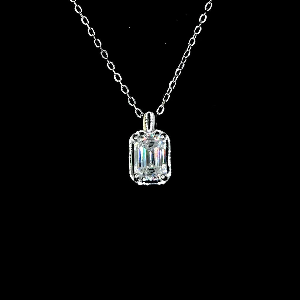 Silver necklace with a rectangular diamond pendant on a black background