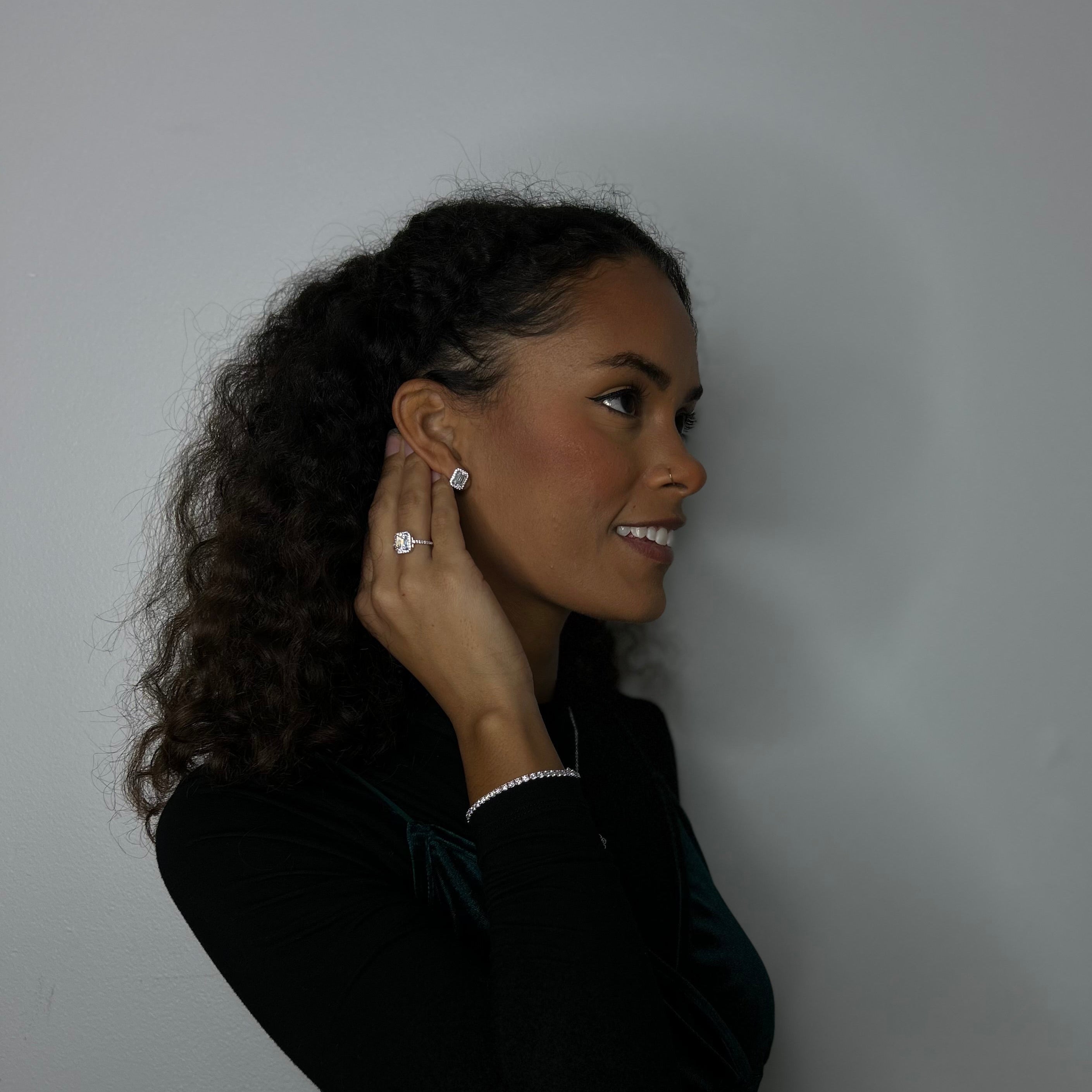 Model in front of white background wearing the Sugar Cube Emerald Set by Lea Fine Jewelry