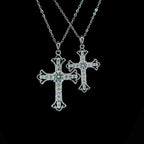 Two silver cross necklaces on a black background